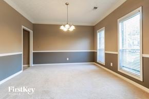 Dacula house for rent - an empty living room with two windows and a chandelier