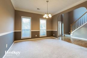 Dacula house for rent - an empty living room with a staircase and window