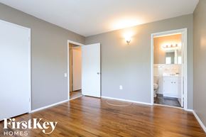 Florissant house for rent - a living room with a hardwood floor and a doorway to a bathroom