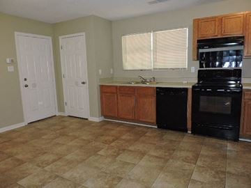 Memphis house for rent - a kitchen with a stove a sink and a refrigerator