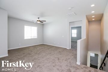 Mesa house for rent - a living room with carpet and a ceiling fan