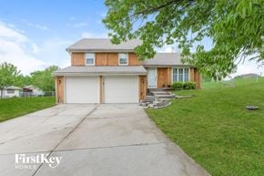 Blue Springs house for rent - a home with a white garage door and a driveway