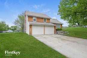 Blue Springs house for rent - a home with a white garage door and a driveway