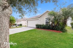 Winter Haven house for rent - a home with a lawn and a palm tree