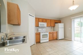 Winter Haven house for rent - a kitchen with white appliances and wooden cabinets