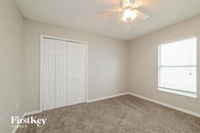 Winter Haven house for rent - a bedroom with carpet and a ceiling fan