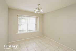 Spring house for rent - a empty dining room with a window and tiled floor