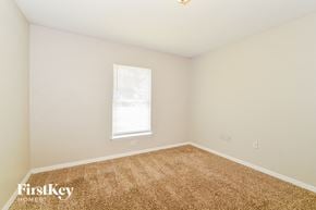 Deltona house for rent - a spacious room with carpet and a window