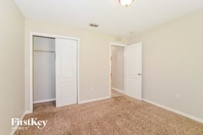 Deltona house for rent - a master bedroom with two closets and a carpeted floor