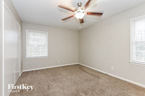 Marietta house for rent - a bedroom with carpet and a ceiling fan