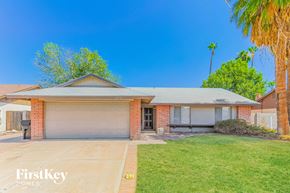 Chandler house for rent - a house with a driveway and a palm tree