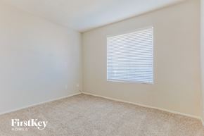 Chandler house for rent - a bedroom with a window and a carpeted floor