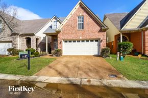 Memphis house for rent - A brick house with a garage door is for sale.