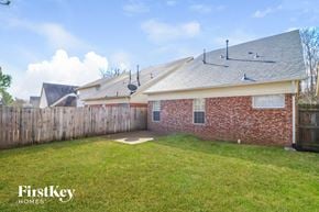 Memphis house for rent - A house with a fence and a grassy yard.