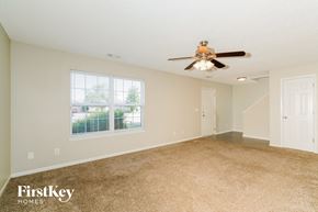 Franklin house for rent - A spacious room with a carpeted floor and a ceiling fan.