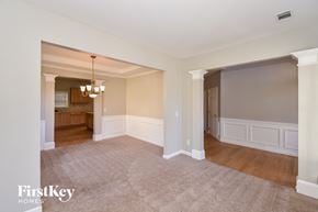 Atlanta house for rent - a living room and dining room with white walls and wood floors