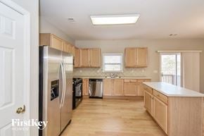 Atlanta house for rent - a kitchen with wooden cabinets and stainless steel appliances