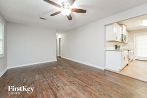 Decatur house for rent - A room with a ceiling fan and wooden flooring.