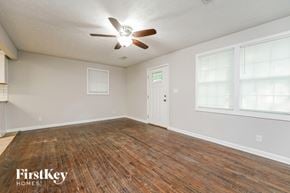 Decatur house for rent - A room with wooden flooring and a ceiling fan.