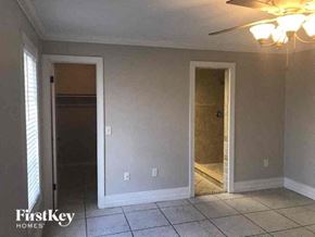 Naples house for rent - A room with a ceiling fan and two doors, one of which is open.