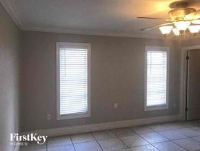 Naples house for rent - A room with two windows and a ceiling fan.