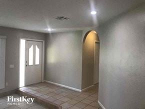 Naples house for rent - A room with a tiled floor and a doorway leading to another room.
