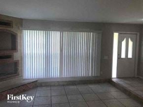 Naples house for rent - A room with a television and a door.
