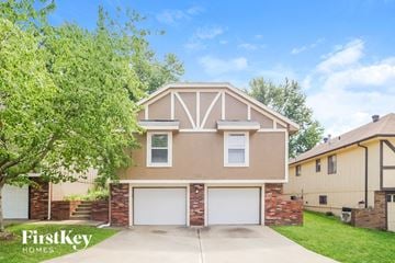 Blue Springs house for rent - a beige house with a white garage door