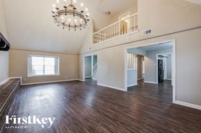Oak Ridge North house for rent - an empty living room with hardwood flooring and a chandelier