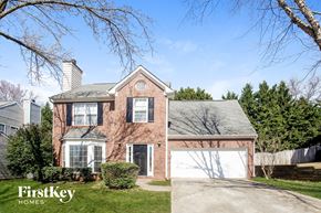 Acworth house for rent - a brick house with a white garage door in front of it