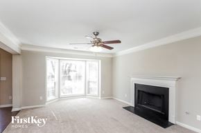 Acworth house for rent - a living room with a fireplace and a ceiling fan