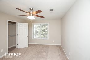 Acworth house for rent - a bedroom with a ceiling fan and a closet