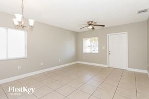 Homestead house for rent - an empty living room with a ceiling fan and tiled floor