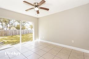 Homestead house for rent - a living room with a large window and a ceiling fan