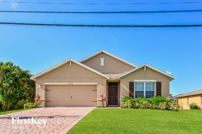 Cape Coral house for rent - A house with a garage and a driveway in front of it.