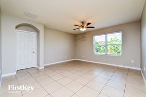 Cape Coral house for rent - A spacious room with a ceiling fan and a window.