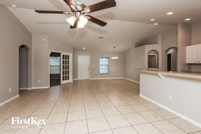 Lehigh Acres house for rent - A spacious room with a ceiling fan and tiled flooring.