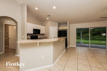 Lehigh Acres house for rent - A spacious kitchen with a countertop and a microwave.