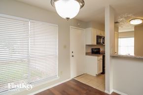 Katy house for rent - an empty kitchen with a large window and a door to the bathroom