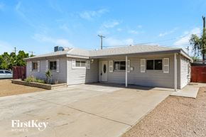 Phoenix house for rent - a small gray house with a concrete driveway