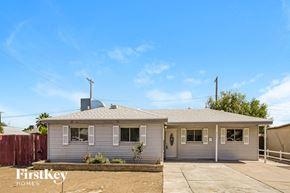 Phoenix house for rent - a white house with a fence and a blue sky