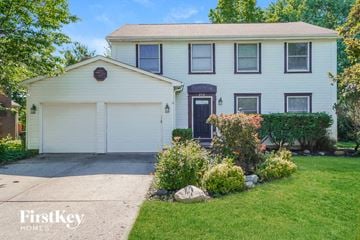 Hilliard house for rent - a white house with a driveway and a white garage door