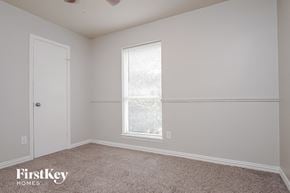 Katy house for rent - a bedroom with white walls and a window and a door