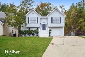 Helena house for rent - A white two-story house with a black door and windows.