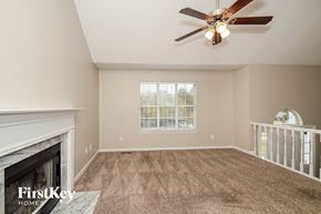 Helena house for rent - A room with a fireplace and a ceiling fan.