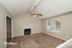 Helena house for rent - A living room with a fireplace and a ceiling fan.