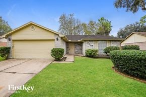 Pearland house for rent - A house with a yellow garage door is for sale by FirstKey Homes.