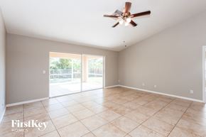 Cape Coral house for rent - an empty living room with a ceiling fan