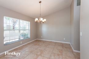 Cape Coral house for rent - a dining room with a chandelier and a large window