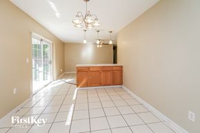Orlando house for rent - an empty dining room with a kitchen and a sliding glass door